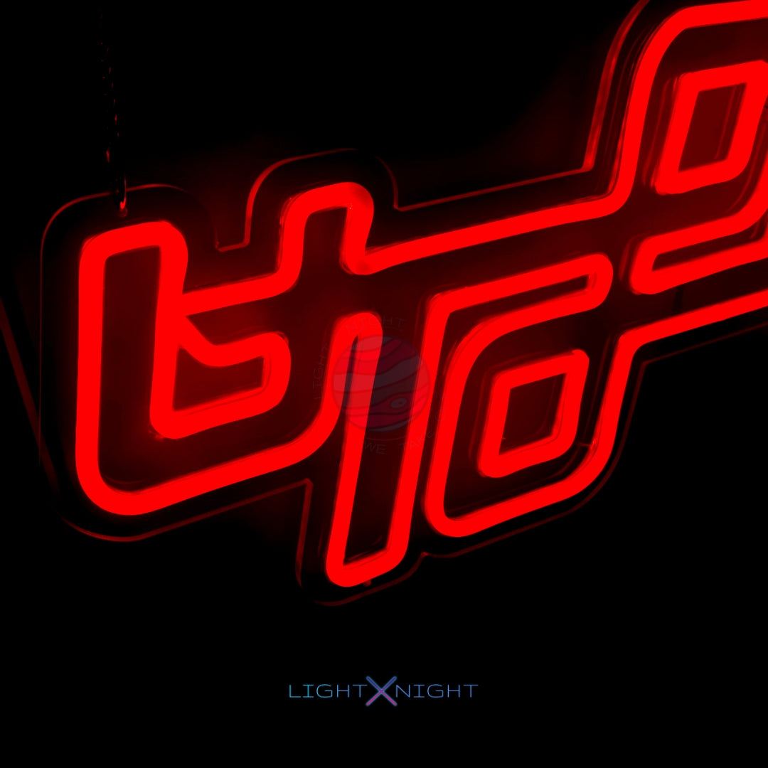 Vibrant orange neon sign displaying the iconic Utopia album logo by Travis Scott