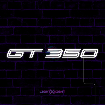 White Ford Mustang Shelby GT350 lettering LED neon sign displayed on a dark brick wall