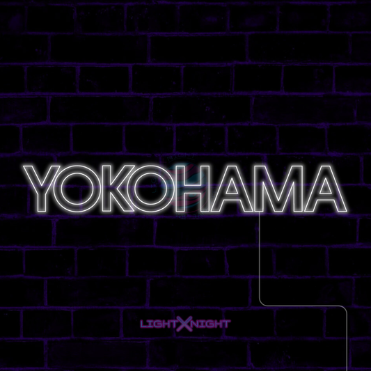 White Yokohama lettering LED neon sign displayed on a dark brick wall