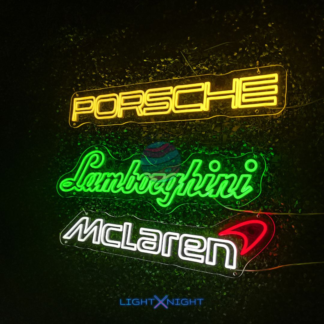 Neon signs of Porsche, Lamborghini, and McLaren 