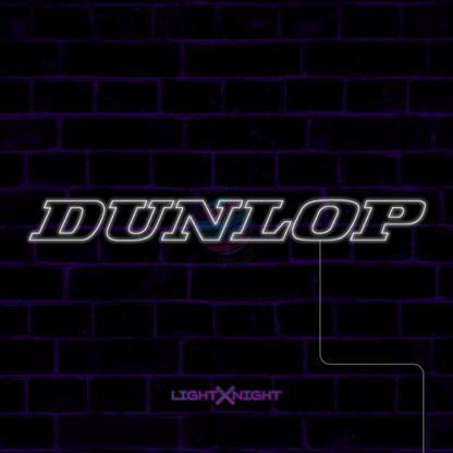 White Dunlop lettering LED neon sign displayed on a dark brick wall