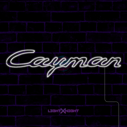 White Porsche Cayman script LED neon sign displayed on a dark brick wall